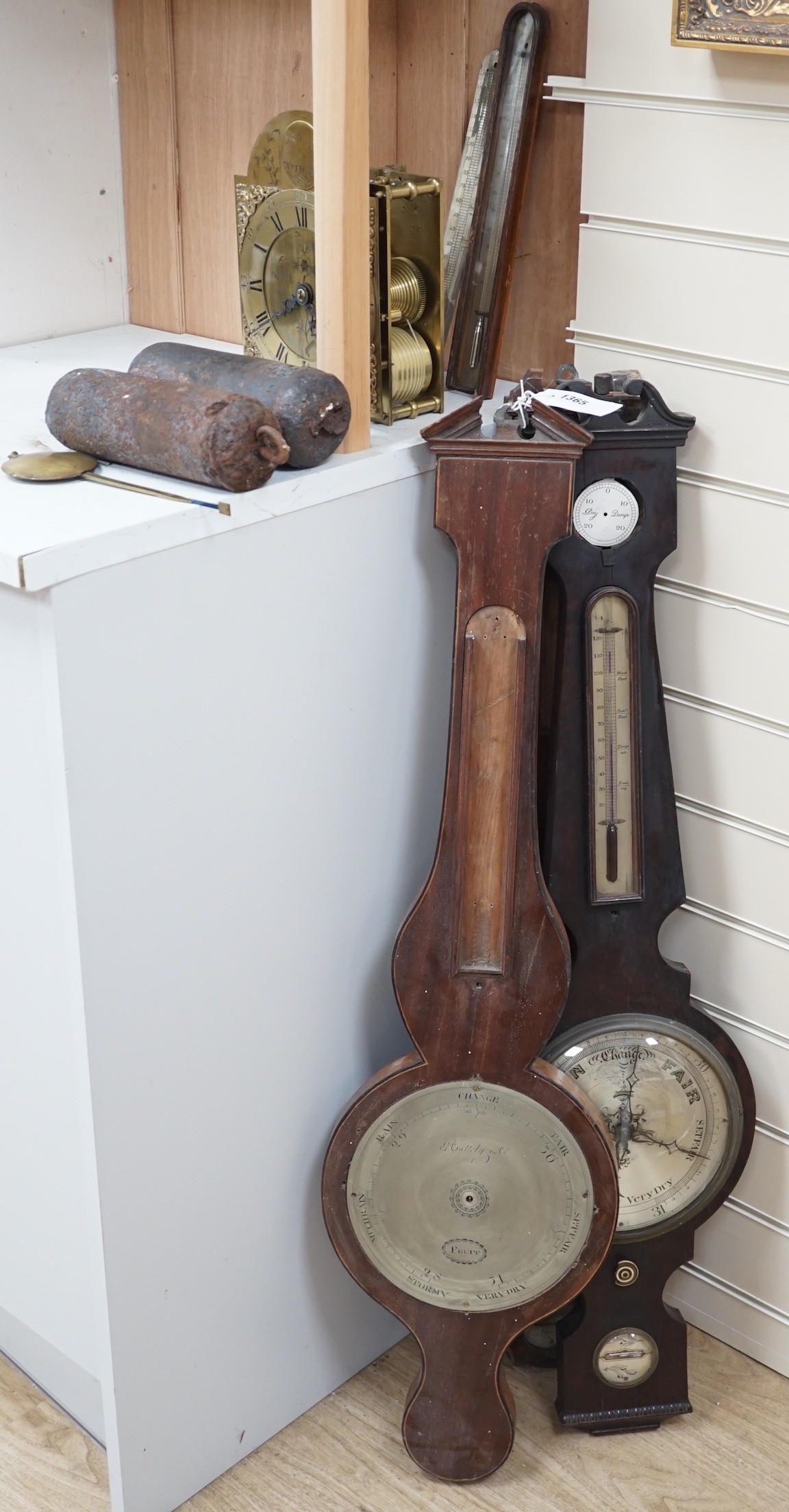 A 19th century bracket timepiece movement, a pair of iron clock weights and three barometer carcasses